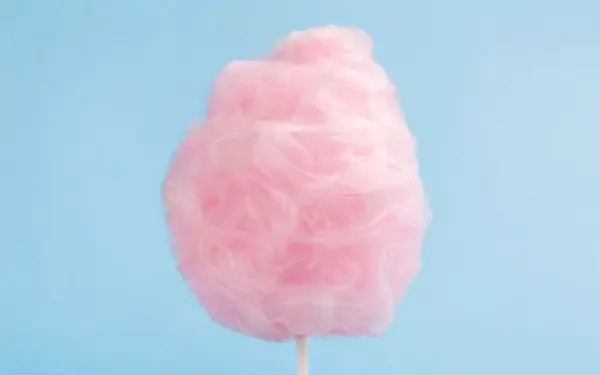 4K Ultra HD PC desktop wallpaper: pink cotton candy on a stick against a soft pale blue background.