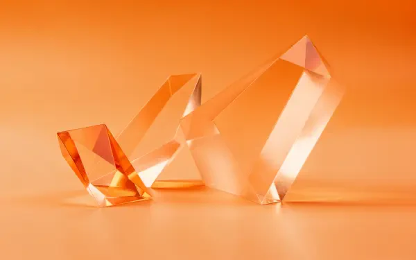 Orange aesthetic 4K Ultra HD PC desktop wallpaper: three translucent faceted crystals on a smooth orange gradient background.