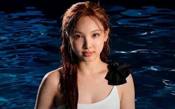 Close-up of a red-haired woman in a white swimsuit, waist‑deep in dark water, K-pop–inspired 5K Ultra HD PC desktop wallpaper background.