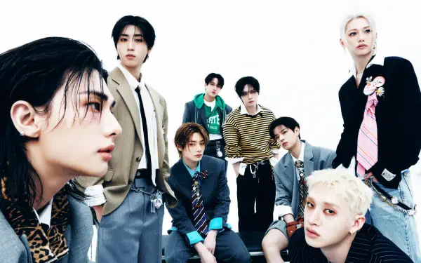 HD desktop wallpaper of an eight-member K-pop boy group, members seated and standing in coordinated suits and casual outfits against a clean white background.