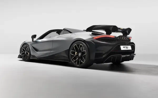 Silver McLaren 788HS roadster, rear three-quarter view with raised wing, studio-lit on a neutral backdrop — 8K Ultra HD PC desktop wallpaper vehicle image.