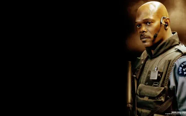 HD PC desktop wallpaper/background from S.W.A.T. (2003) showing a focused SWAT officer in tactical vest and earpiece against a dark background.