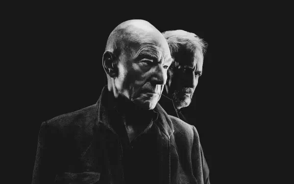 Black-and-white 4K Ultra HD PC desktop wallpaper for Star Trek: Picard featuring two older men in stern profiles emerging from a dark background.