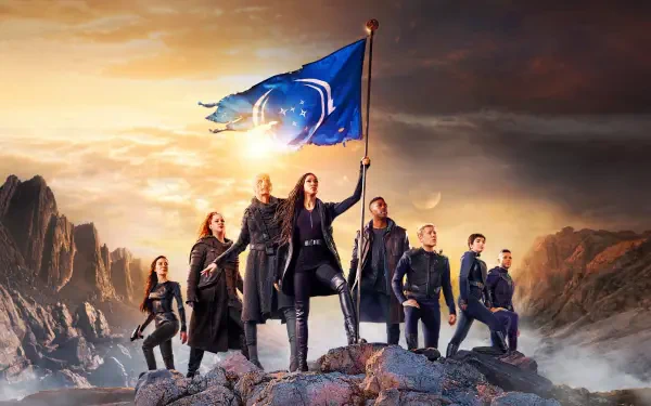 Star Trek: Discovery 4K Ultra HD PC desktop wallpaper — crew on a rocky ridge beneath a dramatic sky as the captain raises a flag bearing the Starfleet emblem.
