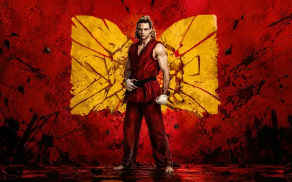 Street Fighter (2026) — Street Fighter 4K Ultra HD PC desktop wallpaper: lone fighter in a red gi poses before a cracked yellow emblem on a blood-red textured backdrop.