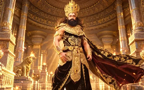 4K Ultra HD PC desktop wallpaper: Ramayana (2026) king–warrior in ornate gold costume and crown, standing in a grand pillared throne hall with flowing cloak and blazing torches.