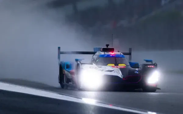 BMW M Hybrid V8 race car charges through a rain-soaked track in the FIA World Endurance Championship, HD desktop wallpaper.