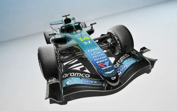 Aston Martin AMR26 Formula One race car in teal and black, featured in a 2K Quad HD desktop wallpaper.