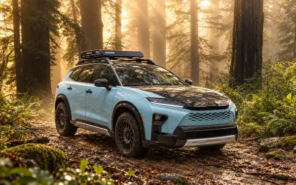 Toyota Crown Signia Woodland Concept SUV on a forest trail, featured in a 2K Quad HD PC desktop wallpaper and background.