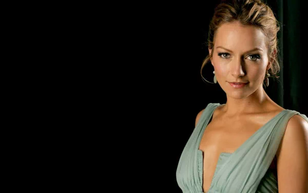 HD desktop wallpaper of celebrity Becki Newton in a teal dress against a dark background.
