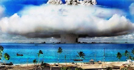A striking HD wallpaper depicting a military explosion over a serene atoll, with clouds and water contrasting against the dramatic scene of destruction.