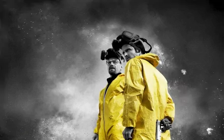 HD desktop wallpaper featuring Aaron Paul as Jesse Pinkman and Bryan Cranston as Walter White from the TV show Breaking Bad, both wearing yellow hazmat suits against a dramatic smoky background.