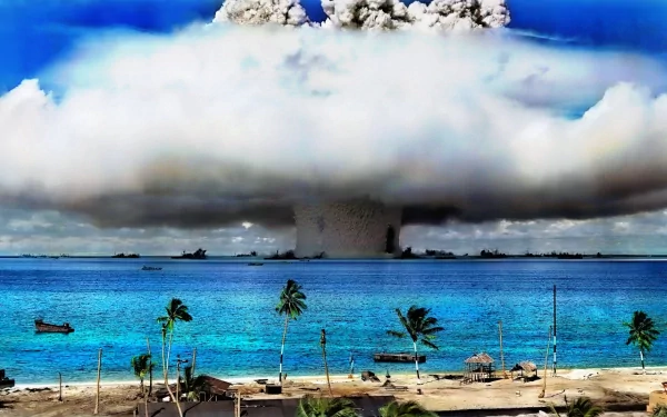 A striking HD wallpaper depicting a military explosion over a serene atoll, with clouds and water contrasting against the dramatic scene of destruction.