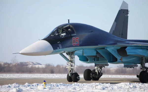 A military Sukhoi Su-34 fighter jet taxiing on a snowy runway, captured in high-resolution 4K Ultra HD for PC desktop background.