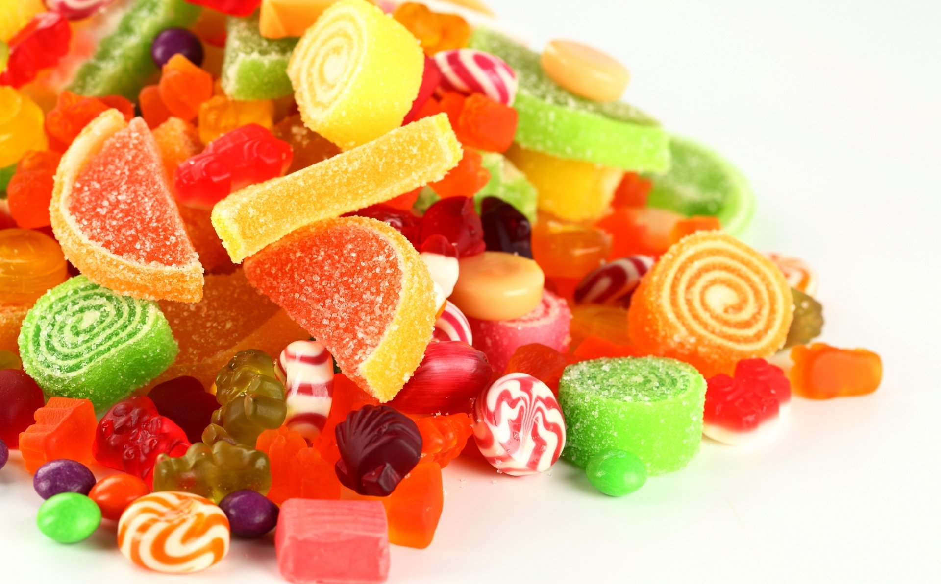A colorful assortment of various candies in bright hues, captured in HD as a vibrant PC desktop wallpaper and background image.