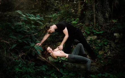 Kristen Stewart and Robert Pattinson share an intimate moment in this HD wallpaper from the movie Twilight, set against a lush, natural background.