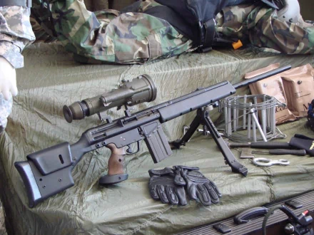 High-definition image of a sniper rifle displayed on a tactical background, featuring accessories like gloves and a scope, emphasizing its man-made design.