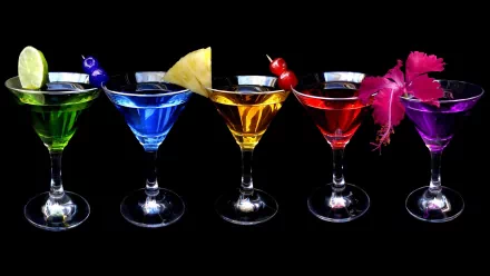 Vibrant cocktails in various colors garnished with fruit and flowers, captured in stunning 4K Ultra HD as a PC desktop wallpaper and background.