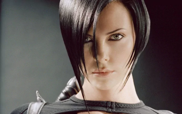 Charlize Theron in a striking pose from the movie *Aeon Flux*, featuring a sleek look that highlights her intense gaze and dynamic character. HD desktop wallpaper.