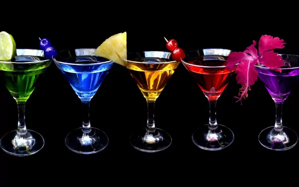 Vibrant cocktails in various colors garnished with fruit and flowers, captured in stunning 4K Ultra HD as a PC desktop wallpaper and background.