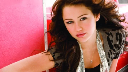 HD PC desktop wallpaper featuring singer Miley Cyrus with flowing hair against a vibrant pink background, representing music and pop culture.