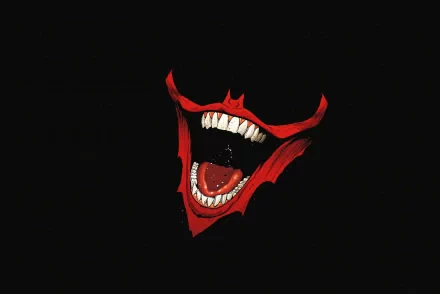 A striking HD PC desktop wallpaper featuring a bold, exaggerated Joker face against a dark background, showcasing sharp teeth and a menacing grin.