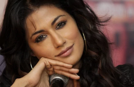 HD PC desktop wallpaper of celebrity Chitrangada Singh with a soft smile and flowing hair in a close-up portrait.