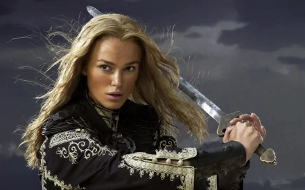 Elizabeth Swann, portrayed by Keira Knightley in Pirates of the Caribbean: At World's End, poised with a sword against a stormy sky in an HD desktop wallpaper.