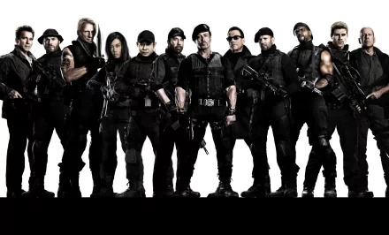 HD desktop wallpaper and background featuring the cast of The Expendables 2, showcasing the ensemble of action characters standing in a powerful formation.