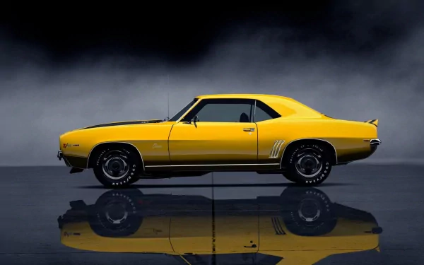 HD PC desktop wallpaper and background of a yellow Chevrolet classic muscle car in profile, reflected on a glossy floor against a moody dark backdrop.