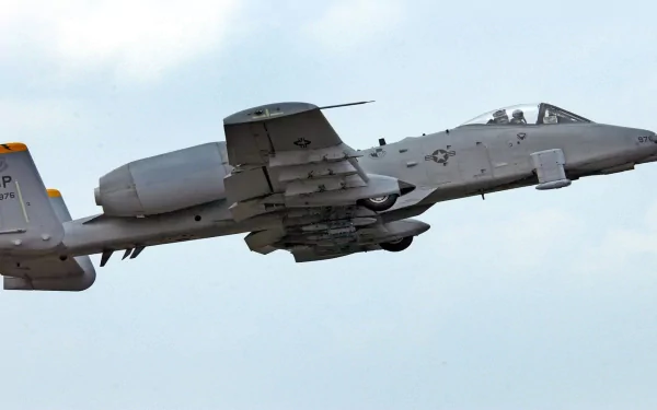 HD desktop wallpaper featuring a Fairchild Republic A-10 Thunderbolt II military aircraft in flight against a clear sky.