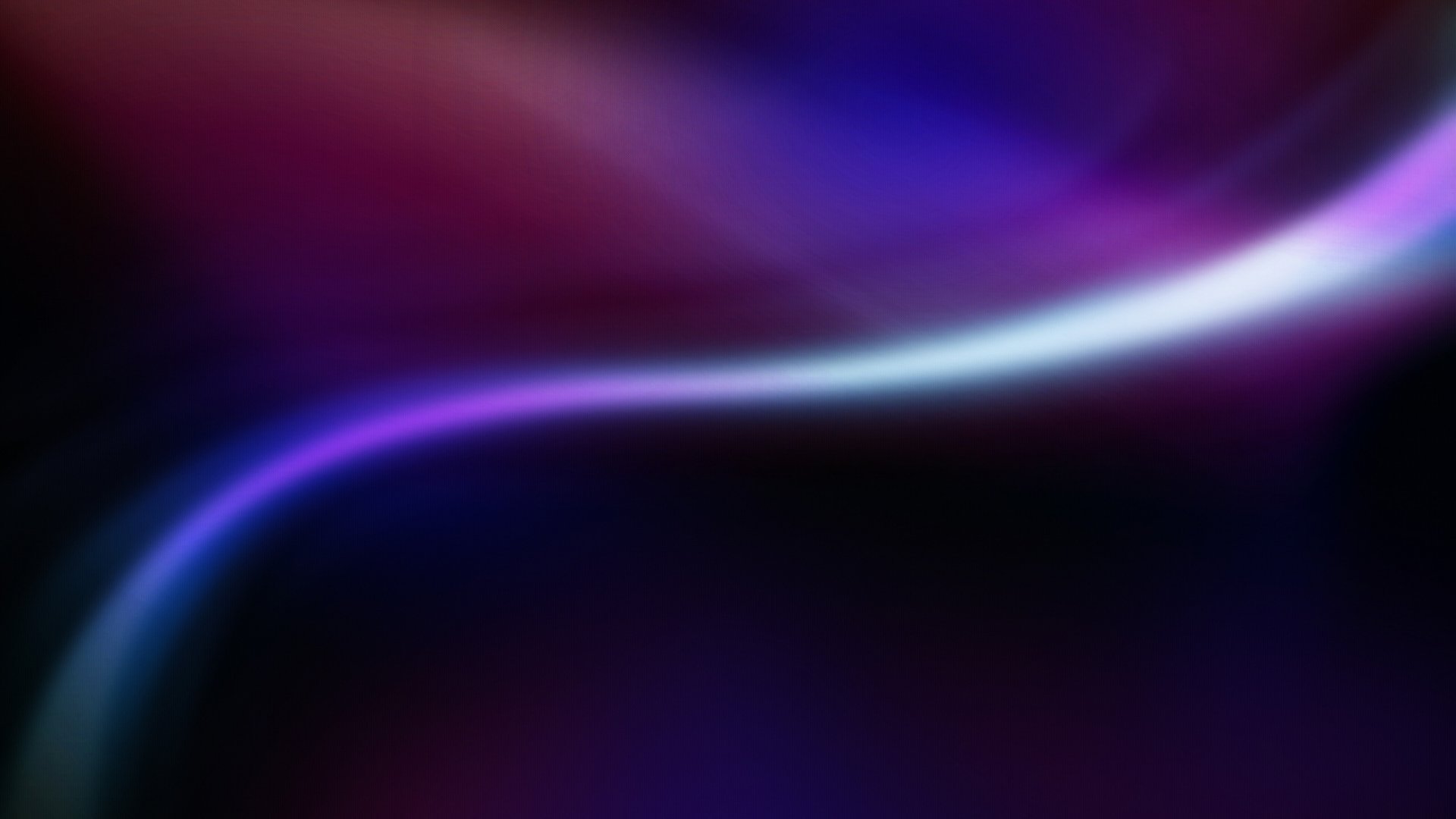 Abstract purple waves flow smoothly across a dark background, creating a dynamic HD desktop wallpaper with vibrant hues and soft gradients.