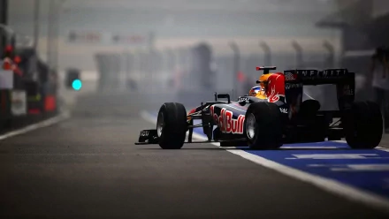 A dynamic F1 racing car from Red Bull, captured in a misty pit lane, makes for an engaging HD desktop wallpaper, celebrating the thrill of sports and speed.
