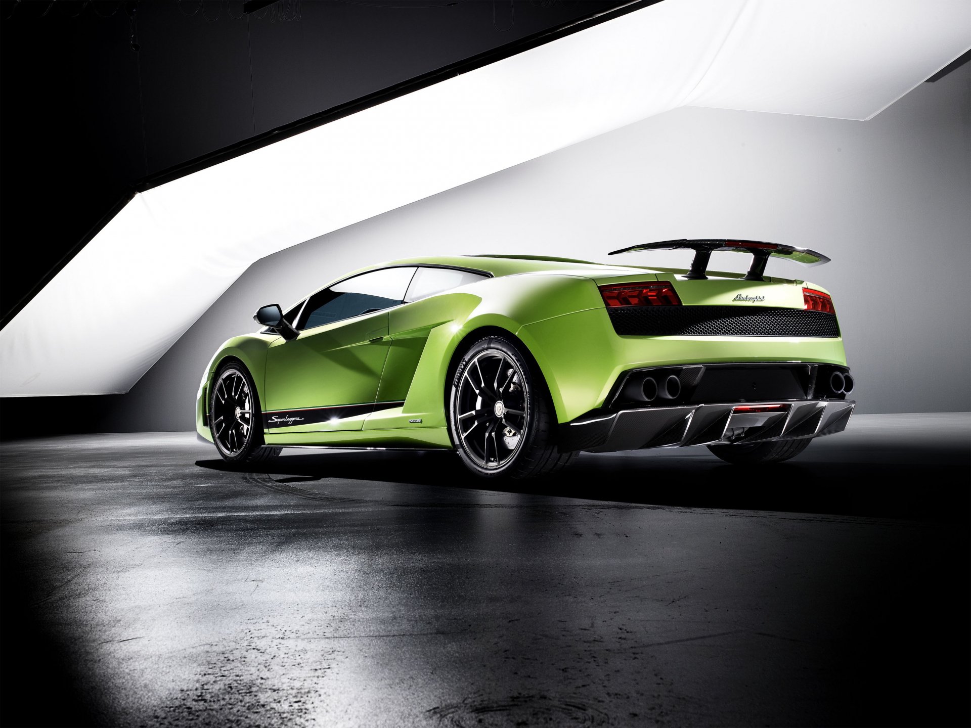 Green Lamborghini Gallardo Superleggera sports car, rear three-quarter view in a minimalist studio with dramatic lighting — 2K Quad HD PC desktop wallpaper/background.