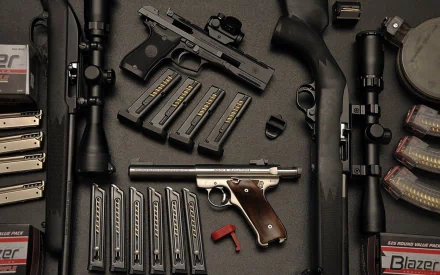 HD PC desktop wallpaper featuring an array of Ruger firearms and magazines arranged on a dark surface, highlighting man-made precision and craftsmanship.