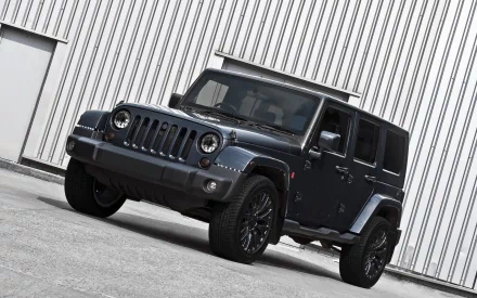 Dark gray Jeep Wrangler parked at an angle against a corrugated metal wall — HD PC desktop wallpaper/background, high-resolution three-quarter front view of the vehicle.