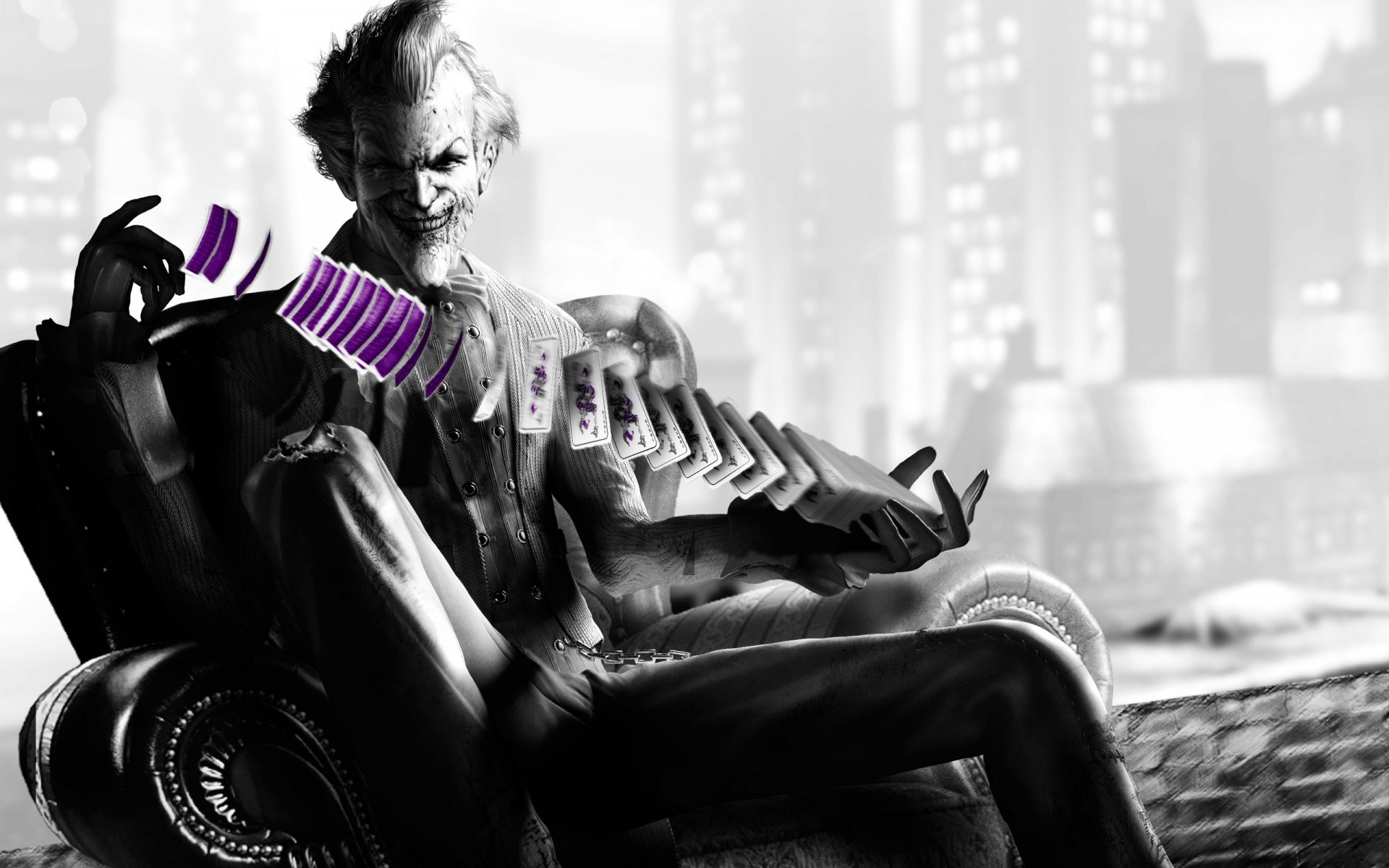 HD PC desktop wallpaper featuring the Joker from the video game Batman: Arkham City, holding a fan of purple cards against a blurred cityscape background.
