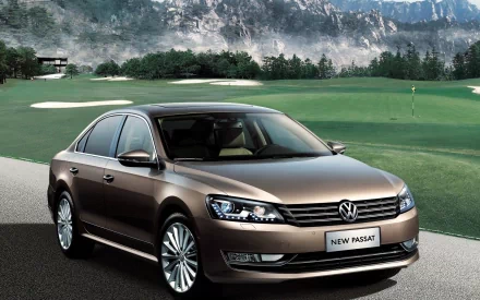 A sleek Volkswagen Passat parked on a golf course with mountains in the background, showcased as an HD PC desktop wallpaper and background.