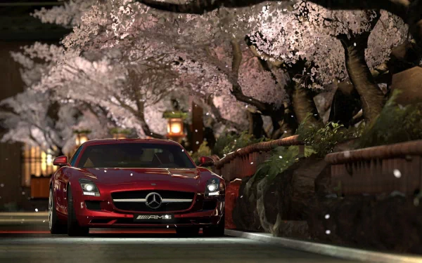 HD PC desktop wallpaper featuring a red Mercedes vehicle parked under blooming cherry blossom trees at night, blending luxury and nature in a serene setting.