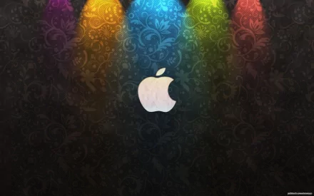 A vibrant HD desktop wallpaper featuring the iconic Apple Inc. logo illuminated by colorful stage lights, set against an elegant dark background with floral patterns.