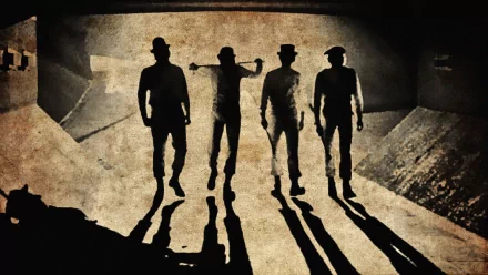 A Clockwork Orange movie HD PC desktop wallpaper/background: four silhouetted figures in bowler hats stride across grimy concrete, long shadows stretching toward the viewer.