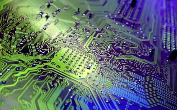 A high-definition background featuring a close-up of a vibrant circuit board, showcasing intricate technology hardware details in shades of green and blue.