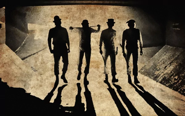 A Clockwork Orange movie HD PC desktop wallpaper/background: four silhouetted figures in bowler hats stride across grimy concrete, long shadows stretching toward the viewer.