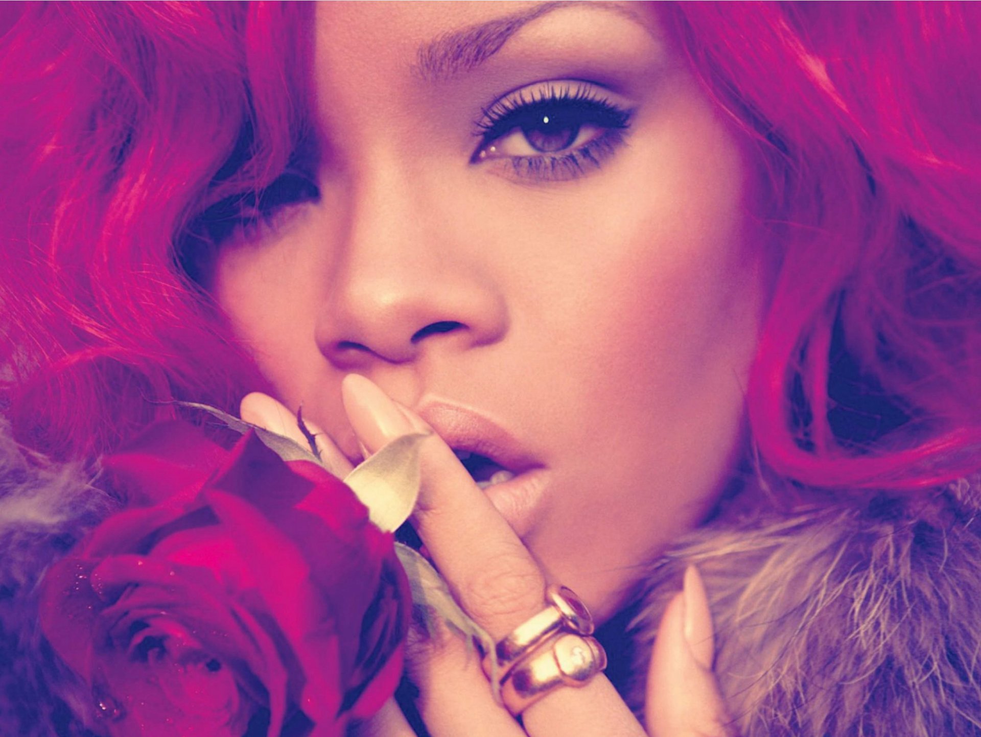 HD PC desktop wallpaper featuring a close-up of Rihanna with vibrant pink hair, highlighting her expressive eyes and soft, contemplative pose, evoking music and style.