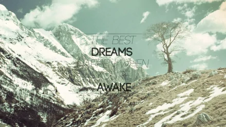 HD desktop wallpaper with a motivational quote, The best dreams happen when you're awake, against a backdrop of snow-covered mountains and a solitary tree on a rocky slope under a cloudy sky.