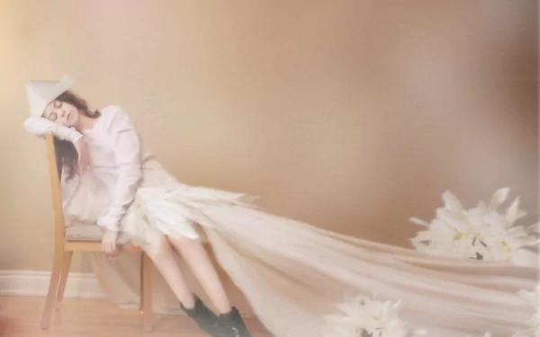 A woman in a flowing dress peacefully sleeping on a chair, captured in an artistic style. The image serves as an HD PC desktop wallpaper and background.