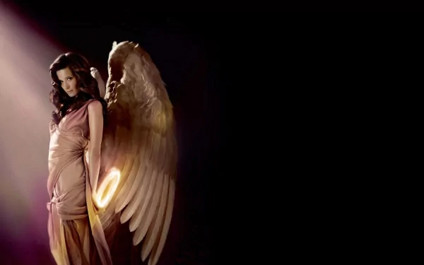 A captivating fantasy angel with majestic wings stands illuminated in a warm glow, creating an enchanting HD PC desktop wallpaper and background.