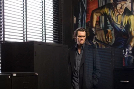 HD PC desktop wallpaper featuring Jim Carrey in a scene from the movie The Number 23, standing in a dimly lit office with a large painting in the background.