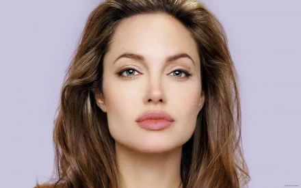 HD desktop wallpaper and background featuring celebrity Angelina Jolie with a neutral expression and a light purple backdrop.