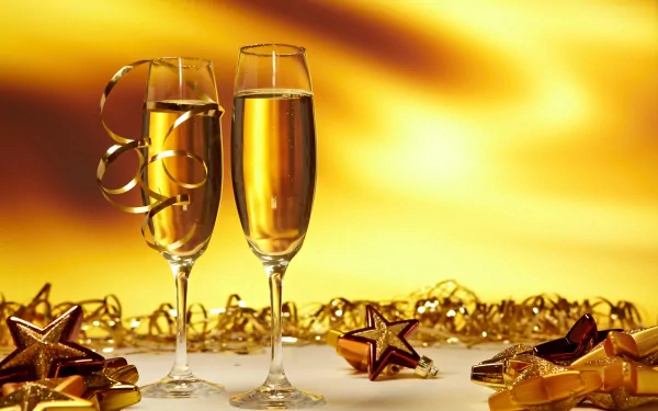 Two champagne flutes surrounded by golden stars and ribbons against a glowing gold background, celebrating New Year in a 4K Ultra HD holiday desktop wallpaper.